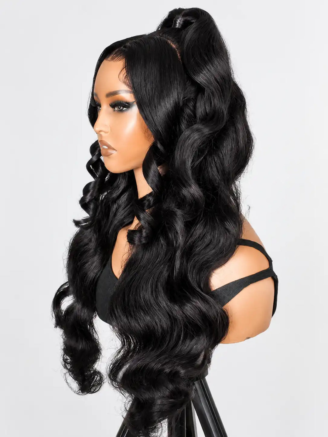 Back view showing 180% density body wave human hair in pre-styled half up half down ponytail